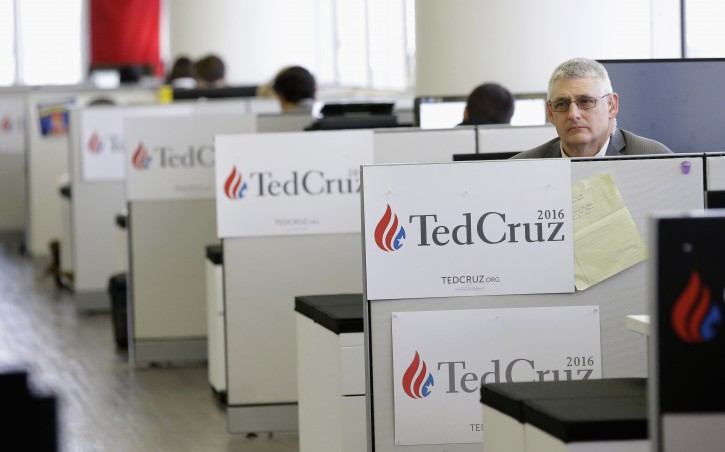 A campaign worker for Republican presidential candidate, Sen. Ted Cruz, R-Texas,  watches as Cruz speaks at a news conference, Monday, Oct. 26, 2015, in Houston. (AP Photo/Pat Sullivan)