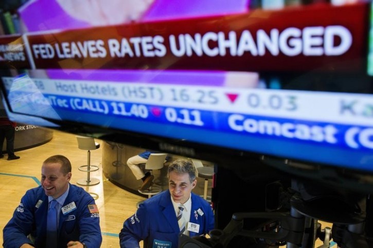 Traders work on the floor of the New York Stock Exchange shortly after an announcement by the Federal Reserve Bank in New York, October 28, 2015.  The U.S. Federal Reserve kept interest rates unchanged on Wednesday and in a direct reference to its next meeting put a December rate hike firmly in play. REUTERS/Lucas Jackson  