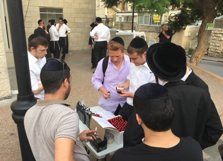 Yeshiva students purchase pepper spray outside the MIR Yeshiva in Jerusalem, October 12, 2015. 