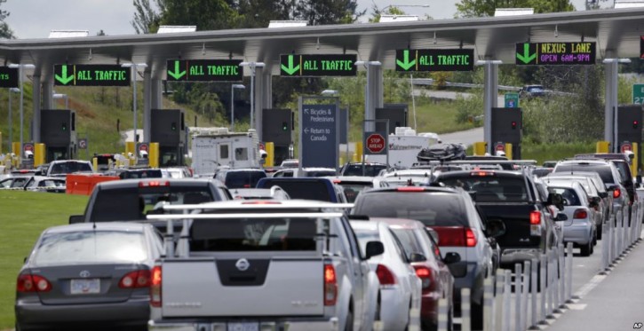 In this Thursday, May 23, 2013 photo, cars from Canada line up to cross into the U.S. in Blaine, Wash.  (AP Photo/Elaine Thompson)