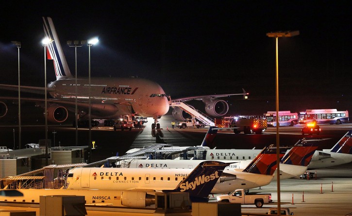 Emergency vehicles are parked near an Air France plane that was diverted to Salt Lake City International Airport, Tuesday, Nov. 17, 2015, in Salt Lake City. Officials said two Air France flights bound for Paris from the U.S. had to be diverted because of anonymous threats issued after they took off, but both planes landed safely. (Ravell Call/The Deseret News via AP) 