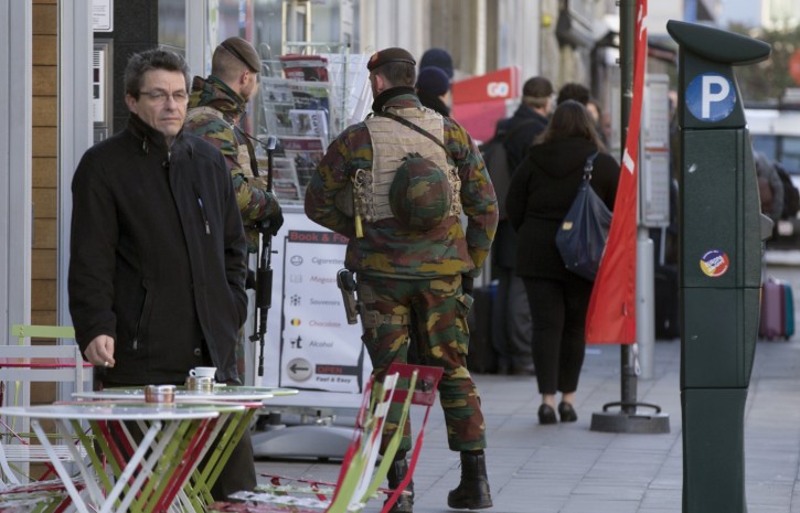 Belgian Army soldiers patrol outside EU headquarters in Brussels on Monday, Nov. 23, 2015. The Belgian capital Brussels has entered its third day of lockdown, with schools and underground transport shut and more than 1,000 security personnel deployed across the country. (AP Photo/Virginia Mayo)
