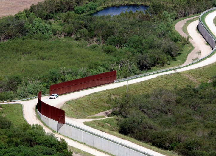 FILE - In this Nov. 16, 2015, aerial file photo, a U.S. border patrol vehicle appears near the border wall near Abram, Texas, from a U.S. Customs and Border Protection helicopter. Nearly 5,000 unaccompanied immigrant children were caught illegally crossing the U.S. border with Mexico in October, almost double the number from October 2014, according to U.S. Customs and Border Protection data. Also, in the figures released Tuesday, the number of family members crossing together nearly tripled from October 2014  from 2,162 to 6,029. (Delcia Lopez/The Monitor via AP)