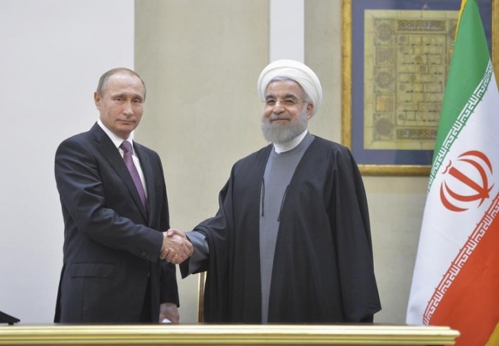 FILE - Russian President Vladimir Putin (L) shakes hands with his Iranian counterpart Hassan Rouhani during a news conference after the talks in Tehran, Iran, November 23, 2015. Picture taken November 23, 2015. REUTERS/Alexei Druzhinin/Sputnik/Kremlin 