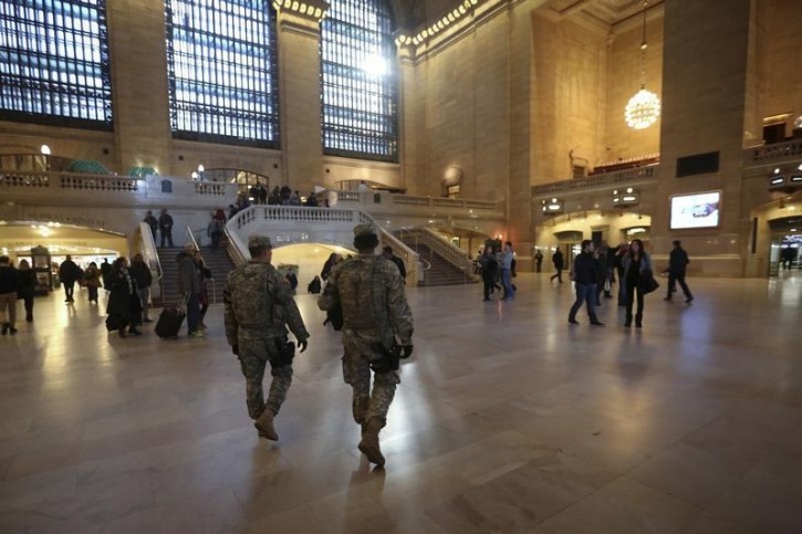 Members of the United States National Guard walk on patrol though Grand Central Terminal the day before Thanksgiving in the Manhattan borough of New York November 25, 2015.     REUTERS/Carlo Allegri
