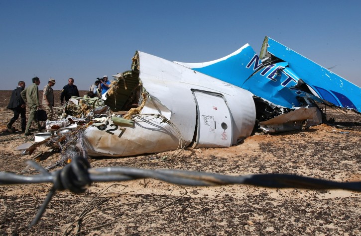  A handout picture provided by the Russian Emergency Ministry press service on 02 November 2015 shows Russian Emergency Situations Minister Vladimir Puchkov (4-L) and unidentified officials near a piece of wreckage of Russian MetroJet Airbus A321 at the site of the crash in Sinai, Egypt, 01 November 2015. EPA