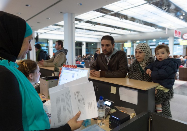 A language professional (L) helps a family from Syria with orientation in the building in Berlin, Germany, 19 November 2015. EPA