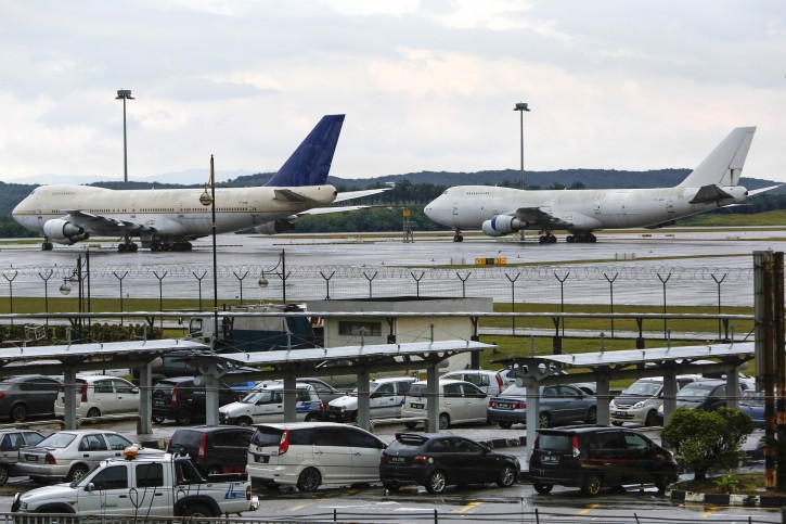 Left to right, two of the three abandoned planes with tail numbers, TF-ARM and TF-ARN is seen taxied on the tarmac of Kuala Lumpur International Airport in Sepang, Malaysia, Wednesday, Dec. 9, 2015. Malaysiaâs airport operator has an unusual dilemma after three large Boeing planes were left abandoned at the countryâs main airport for more than a year. (AP Photo/Joshua Paul)
