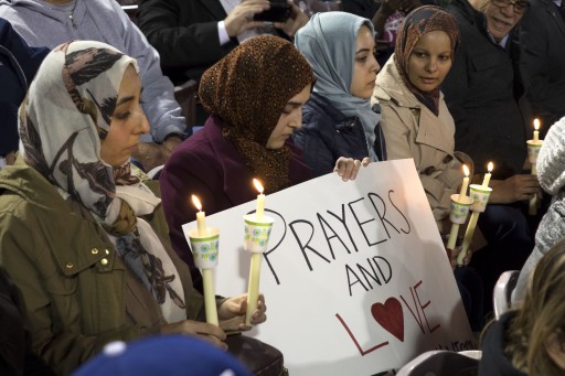 Muslim mourners hold candles and a sign reading 'Prayers and Love' during a candlelight vigil for mass shooting victims in San Bernardino, California, USA, 03 December 2015.  EPA