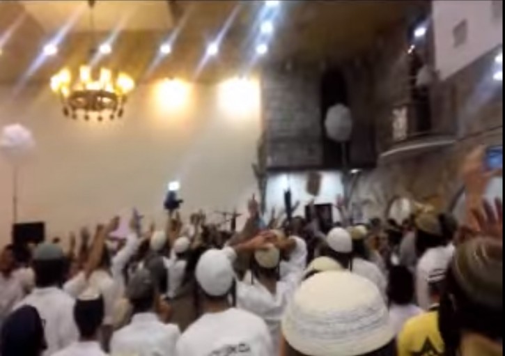 This still from the video of a wedding among right-wing activists shows dancers brandishing rifles, a twist on traditional wedding dances. (Screenshot)