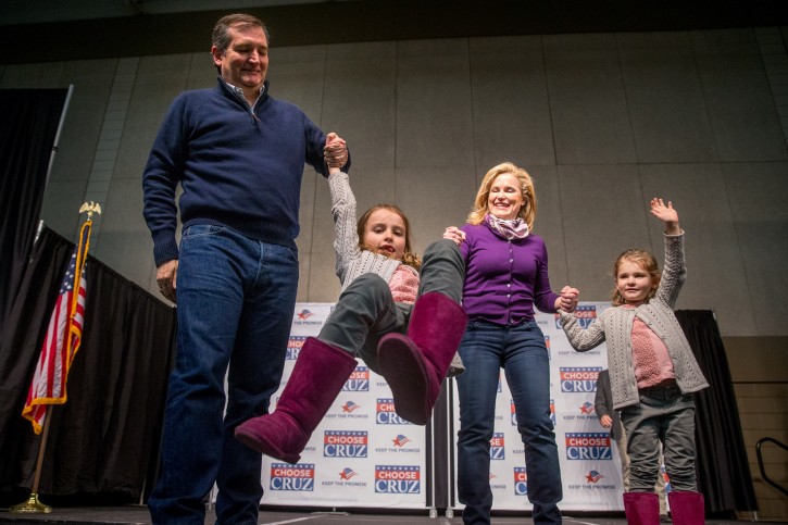 Republican presidential candidate Sen. Ted Cruz, R-Texas, and his wife Heidi swing their daughter Caroline, 7, as their younger daughter Catherine, 4, right, waves to members of the audience after Cruz spoke at a rally at the Five Sullivan Brothers Convention Center in Waterloo, Iowa, Saturday, Jan. 23, 2016. (AP Photo/Andrew Harnik)