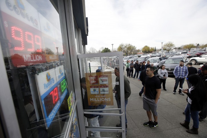 People line up to buy Powerball lottery tickets at Kavanagh Liquors on Tuesday, Jan. 12, 2016, in San Lorenzo, Calif. The Powerball jackpot has grown to over 1 billion dollars for the next drawing on Wednesday. (AP Photo/Marcio Jose Sanchez)