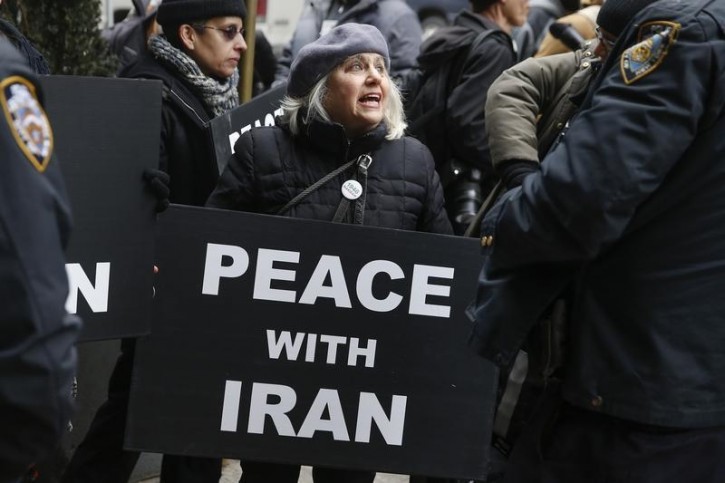 FILE - A demonstrator holds a sign during a rally near the Israeli Consulate in New York March 3, 2015.  Reuters