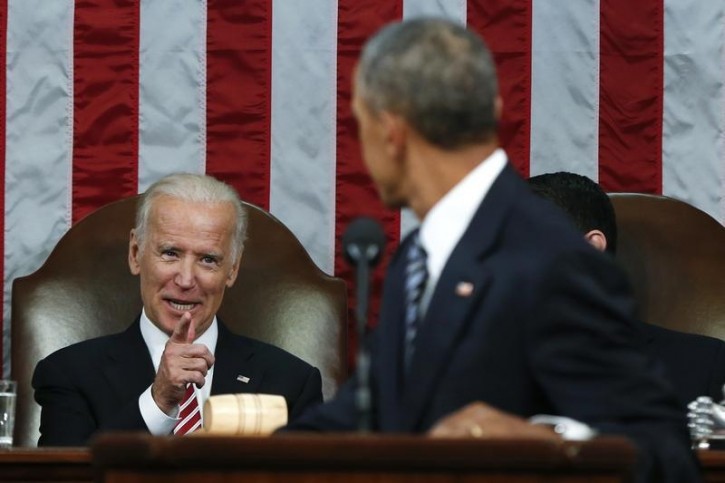 Vice President Joe Biden (L) points to U.S. President Barack Obama while Obama delivered his final State of the Union address to a joint session of Congress in Washington January 12, 2016. REUTERS/Evan Vucci/Pool