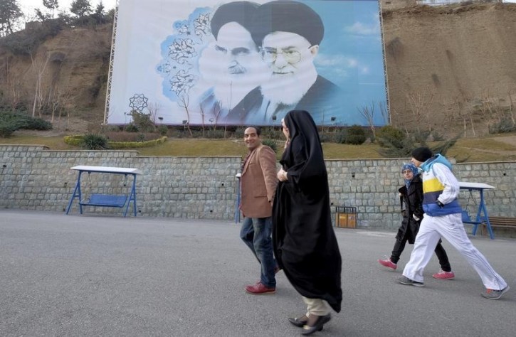 FILE - Iranians walk past a large picture of Iran's late leader Ayatollah Ruhollah Khomeini (L), and Iran's Supreme Leader Ayatollah Ali Khamenei at a park in Tehran, Iran, January 17, 2016. REUTERS/Raheb Homavandi/TIMA