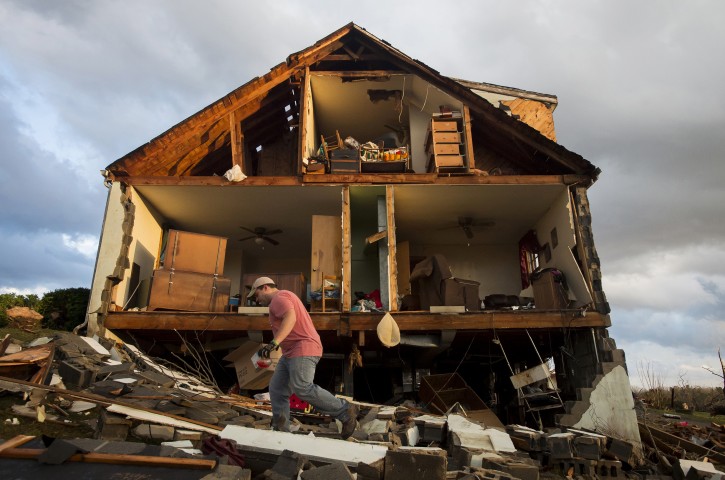 Nick Mobley helps clean up a house owned by a family friend, Wednesday, Feb. 24, 2016, after a storm hit Appomattox County, Va. A powerful storm system swept across the East Coast on Wednesday, knocking out power to tens of thousands of homes and businesses in the region. (Jill Nance/The News & Advance via AP)