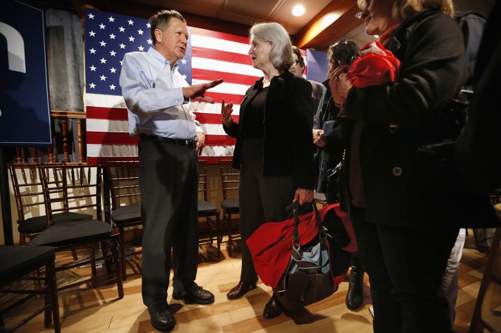 Republican presidential candidate, Ohio Gov. John Kasich talks with a member of the audience at a town hall-style campaign event at the Three Chimneys Inn, Wednesday, Feb. 3, 2016, in Durham, N.H. (AP Photo/Robert F. Bukaty)