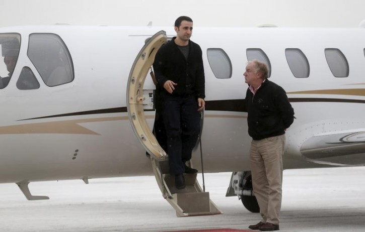 Former U.S. Marine Amir Hekmati, recently released from an Iranian prison, steps out of the plane piloted by Mike Karnowski (R), as he arrives at an airport in Flint, Michigan January 21, 2016.      REUTERS/Rebecca Cook