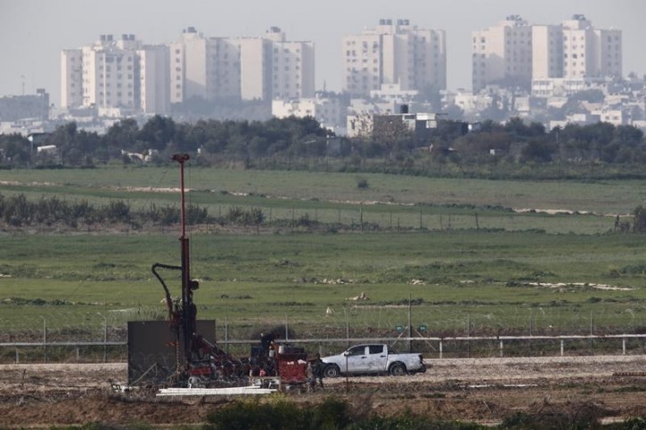 A drill can be seen at work on the line of the Israeli border with Gaza February 1, 2016. REUTERS