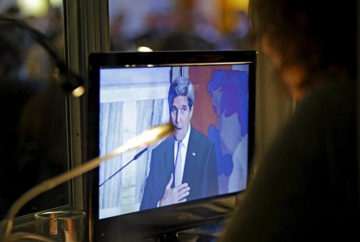 An interpreter works in her box as a monitor shows U.S. Secretary of State John Kerry during a news conference following a ministerial meeting of the so-called "anti-Islamic State coalition" in Rome, Italy, February 2, 2016. REUTERS/Max Rossi -