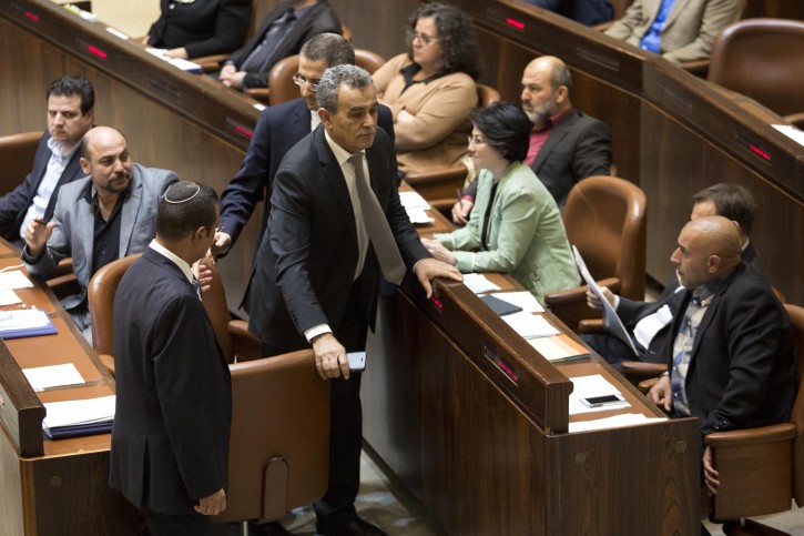 Israeli-Arab Knesset member Jamal Zahalka (C) is escorted out by the  Knesset guards after shouting towards  Israeli Prime Minister Benjamin Netanyahu (L) during a voting season  at the Knesset (Israeli parliament) in Jerusalem, Israel, 08 February 2016. The Israeli  Knesset Ethics Committee decided to suspend for four months the Arab Knesset members Jamal Zahalka,  Hanin Zoabi and Basel Ghattas after meeting with the families of Palestinian terrorists who carry out  attacks against Israelis.  EPA/ABIR SULTAN