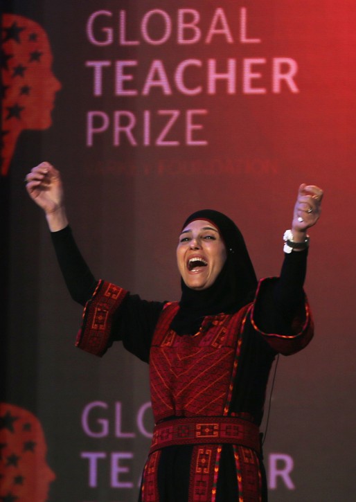 FILE - In this Sunday, March 13, 2016 file photo, Palestinian primary school teacher Hanan al-Hroub reacts after she won the second annual Global Teacher Prize, in Dubai, United Arab Emirates. The U.K.-based foundation that awarded a al-Hroub a $1 million prize for preaching nonviolence is sticking by its choice following revelations that the womans husband participated in an attack that killed six Israelis three decades ago. (AP Photo/Kamran Jebreili, File)