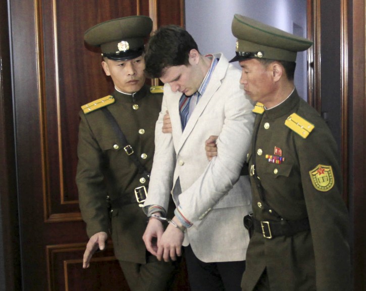 American student Otto Warmbier, center, is escorted at the Supreme Court in Pyongyang, North Korea, Wednesday, March 16, 2016. North Korea's highest court sentenced Warmbier, a 21-year-old University of Virginia undergraduate student, from Wyoming, Ohio, to 15 years in prison with hard labor on Wednesday for subversion. (AP Photo/Jon Chol Jin)