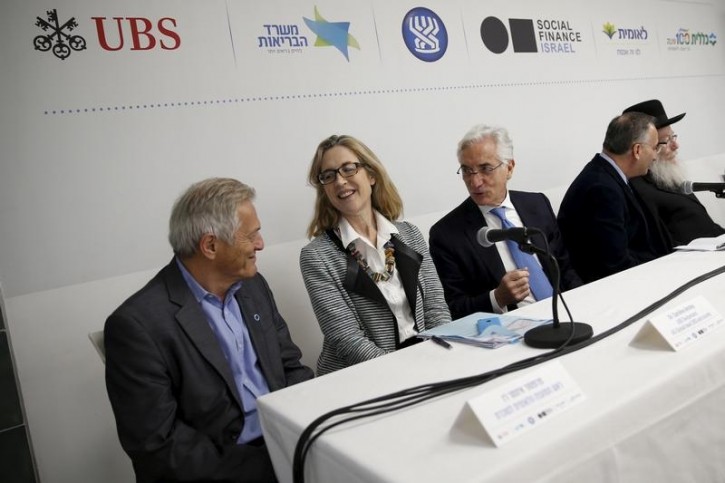 Sir Ronald Cohen, Chairman (3rd L) of the Global Social Impact Investment Steering Group, sits next to Caroline Anstey (2nd L), Global Head at UBS and Society, during a news conference in Tel Aviv March 14, 2016. REUTERS/Baz Ratner