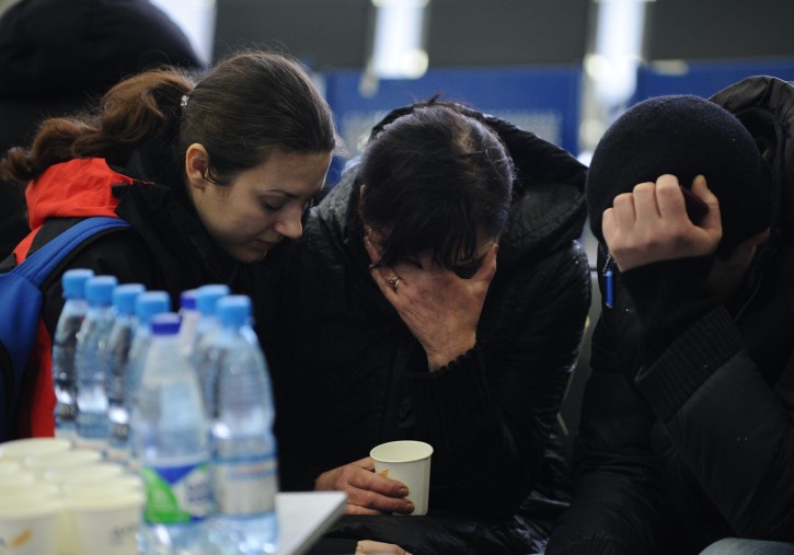 A Russian Emergency Situations Ministry employee, left, tries to comfort a relative of the plane crash victims at the Rostov-on-Don airport, about 950 kilometers (600 miles) south of Moscow, Russia Saturday, March 19, 2016. An airliner from Dubai crashed early Saturday while landing in the southern Russian city of Rostov-on-Don in strong winds, Russian officials said. (AP Photo)