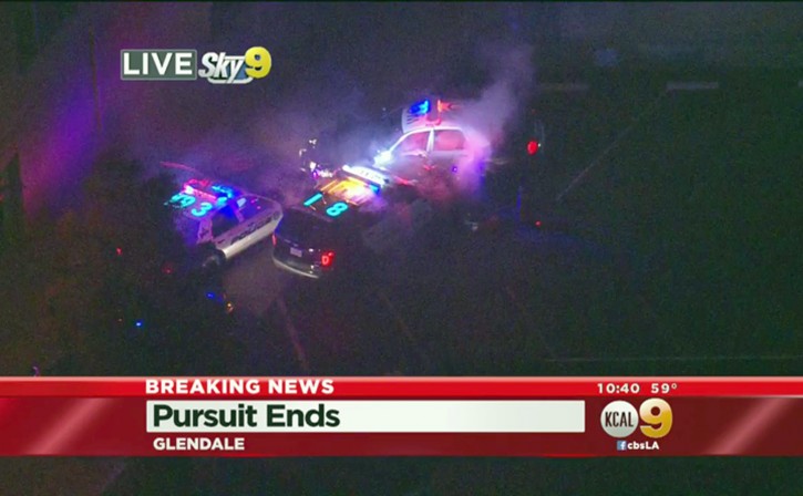 In this March 13, 2016 still image from video provided by KCBS-TV/KCAL9, West Covina, Calif., police officers rammed a stolen patrol car, top, and then shot and killed the suspect after an hour-long chase across Southern California freeways that ended with the dramatic collision in an alley in Glendale, Calif. The driver hit speeds topping 100 mph during the pursuit that was broadcast live on news stations Sunday night.(KCBS-TV/KCAL9 via AP)