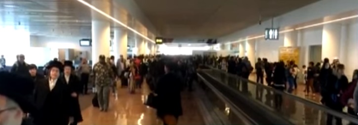 Orthodox Jews are seen fleeing the airport