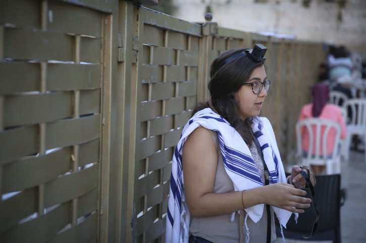 A young Jewish woman wears tefillin and a talit (prayer shawl) as she takes part in the Women of the Wall Rosh Hodesh prayers at the Western Wall in Jerusalem's Old City, on Friday, May 30, 2014. Photo by Hadas Parush/Flash 90 *