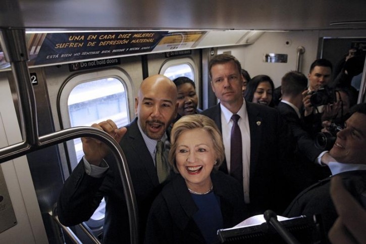 U.S. Democratic presidential candidate Hillary Clinton (C) rides the New York City Subway with Bronx Borough President Ruben Diaz (L) in the Bronx borough of New York, April 7, 2016. REUTERS/Brendan McDermid 