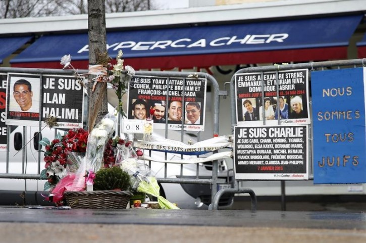 FILE - Flowers and messages in tribute to the victims of last year's January attacks are seen in front of the Hyper Cacher kosher supermarket at the Porte de Vincennes in Paris, France, January 6, 2016. Reuters