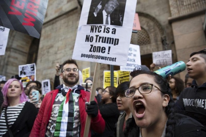 Protesters demonstrate against Republican U.S. presidential candidate Donald Trump in midtown Manhattan in New York City April 14, 2016.   REUTERS/Elizabeth Shafiroff