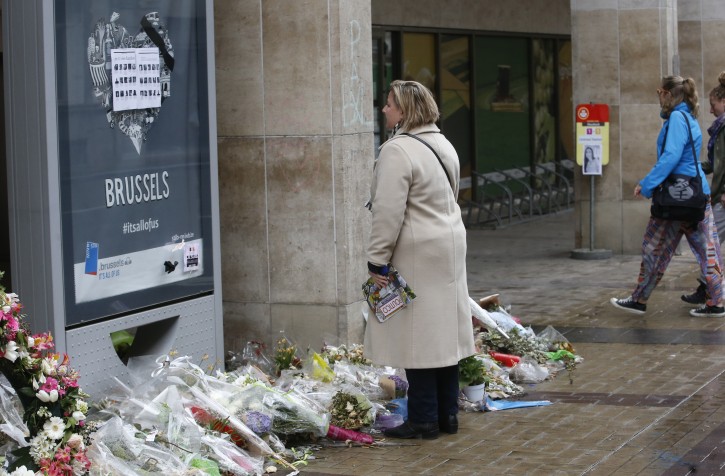 A woman stands at a memorial at the entrance to Maalbeek metro station, during its reopening one month after it was closed due to the terrorist attacks, in Brussels, Belgium, 25 April 2016. EPA