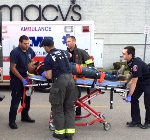 The suspect in attacks at Silver City Galleria mall is transported on a gurney into an ambulance by medical personnel in Taunton, Mass., Tuesday, May 10, 2016. Multiple people have been stabbed in separate deadly attacks at the mall and a home in Massachusetts. Authorities say an off-duty law enforcement officer shot and killed the suspect. (Charles Winokoor/The Daily Gazette via AP) 