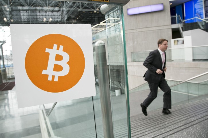 FILE - In this April 7, 2014 file photo, a man arrives for the Inside Bitcoins conference and trade show in New York. An Australian man long thought to be associated with the digital currency Bitcoin has publicly identified himself as its creator. BBC News said Monday, May 2, 2016  that Craig Wright told the media outlet he is the man previously known by the pseudonym Satoshi Nakamoto.(AP Photo/Mark Lennihan, File)