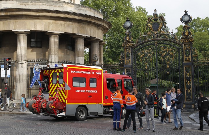 A fire truck is parked at the entrance to Monceau parc in the center of Paris, France, Saturday, May 28, 2016, after a lightning bolt crashed down onto a Paris park, striking 11 people at a child's birthday party. (AP Photo/Francois Mori)