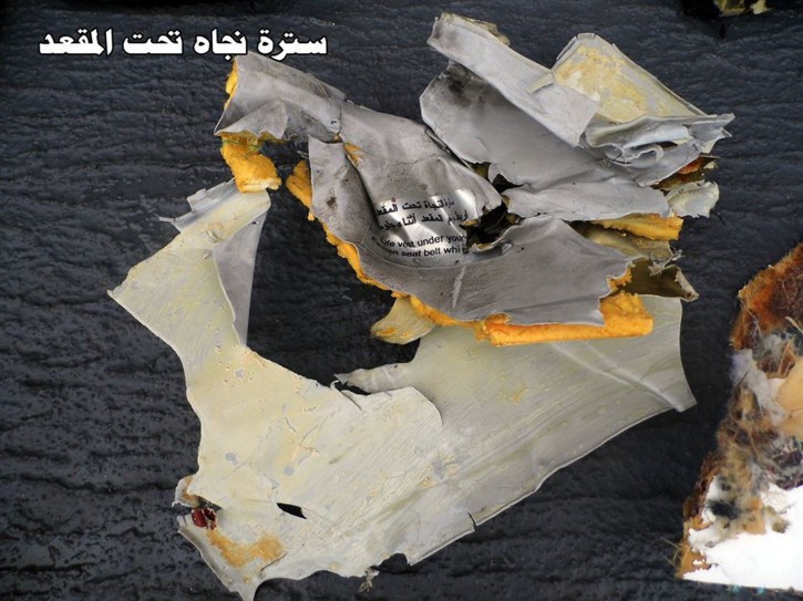 This picture posted Saturday, May 21, 2016, on the official Facebook page of the Egyptian Armed Forces spokesman shows a life vest from EgyptAir flight 804. Search crews found floating human remains, luggage and seats from the doomed EgyptAir jetliner Friday but face a potentially more complex task in locating bigger pieces of wreckage and the black boxes vital to determining why the plane plunged into the Mediterranean. Arabic reads:  Under the seat life vest.  (Egyptian Armed Forces via AP)