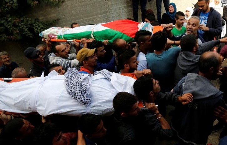 Mourners carry the bodies of Palestinian woman Maram Abu Ismail and her brother Ibrahim Taha, who were shot dead by Israeli police last month, during their funeral near the West Bank city of Ramallah May 23, 2016. REUTERS/Mohamad Torokman
