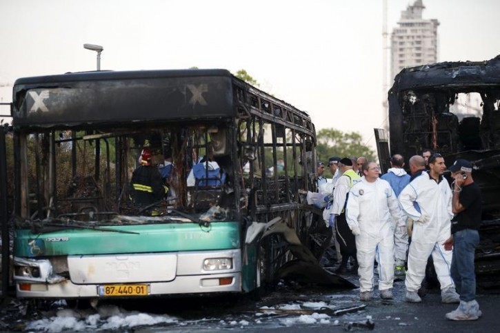 FILE - Israeli police forensic experts work at the scene after an explosion tore through a bus in Jerusalem on Monday and set a second bus on fire, in what an Israeli official said was a bombing, April 18, 2016. REUTERS/Ronen Zvulu
