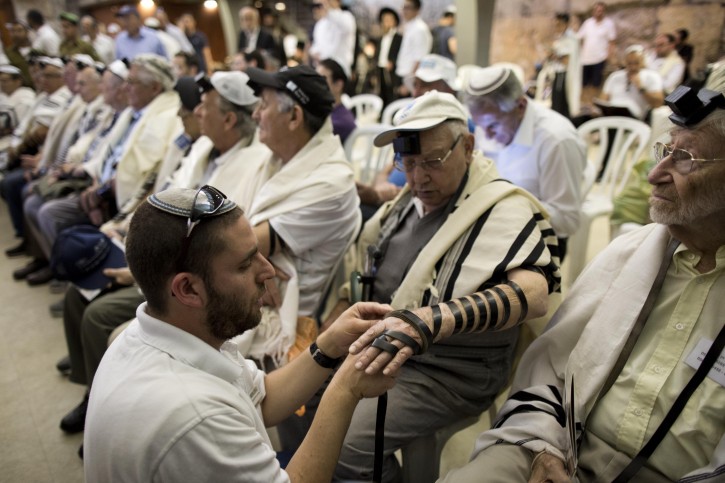 Holocaust survivors wrapped in prayer shawls and Tefillin are helped during their Bar Mitzvah ceremony at the Western Wall in Jerusalem's Old City, Israel, 02 May 2016. EPA