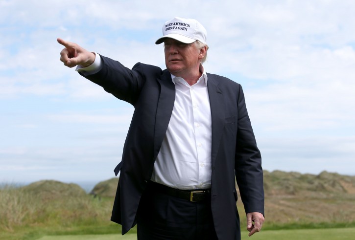 US presidential candidate Donald Trump points as he chats with the media after he arrived at the Trump International Golf Links at Balmedie, near Aberdeen, Scotland, Saturday June 25, 2016.  Presidential hopeful Donald Trump is on a short break away from his presidential campaign. (Andrew Milligan / PA via AP) 