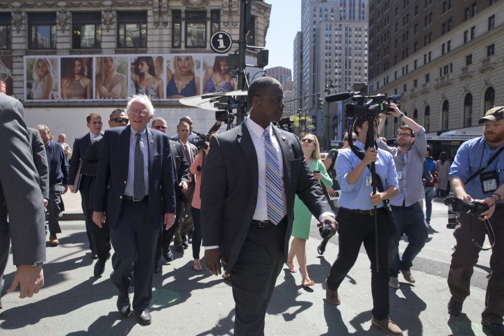 In this photo taken April 18, 2016, Democratic presidential candidate Sen. Bernie Sanders, I-Vt., is surrounded by reporters and Secret Service agents as he takes a walk in midtown Manhattan in New York. Being mathematically eliminated from the race to win the Democratic presidential nomination hasnât stopped apSanders from continuing his White House bid or be protected by a group of highly trained, costly Secret Service agents. (AP Photo/Mary Altaffer)