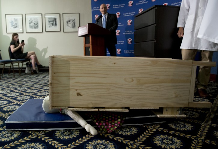 Consumer Product Safety Commission (CPSC) Chairman Elliot Kaye watches during a demonstration of how an Ikea dresser can tip and fall on a child during a news conference at the National Press Club in Washington, Tuesday, June 28, 2016. Ikea is recalling 29 million chests and dressers after six children were killed when the furniture toppled over and fell on them. (AP Photo/Carolyn Kaster)
