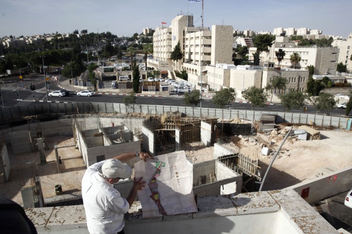 In this May 17, 2016 photo, Israeli lawyer Stephen Berman inspects a construction site on land owned by Palestinian Mohammad Abu Taâa, in east Jerusalem. AP