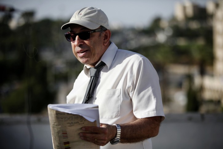 In this photo taken Tuesday, May 17, 2016, Lawyer Stephen Berman is seen near a construction site east Jerusalem, A Palestinian landowner in Jerusalem was surprised to wake up one morning a few years ago to discover an office trailer and storage unit on his property had vanished.(AP Photo/Mahmoud Illean)