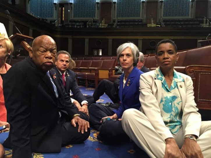 FILE - A photo tweeted from the floor of the U.S. House by Rep. Donna Edwards (R) shows Democratic members of the U.S. House of Representatives, including herself and Rep. John Lewis (L) staging a sit-in on the House floor "to demand action on common sense gun legislation" on Capitol Hill in Washington, United States, June 22, 2016.  REUTERS/Rep. Donna Edwards/Handout 