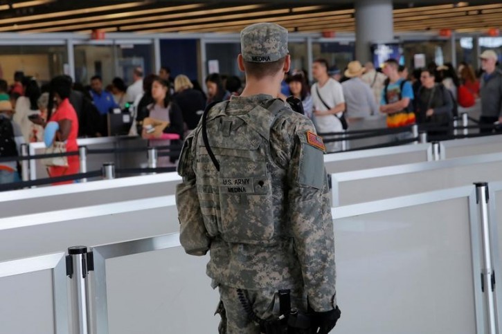 A U.S. Army Specialist monitors the security line at John F. Kennedy international Airport in the Queens borough of New York, U.S., June 29, 2016.  REUTERS/Andrew Kelly 